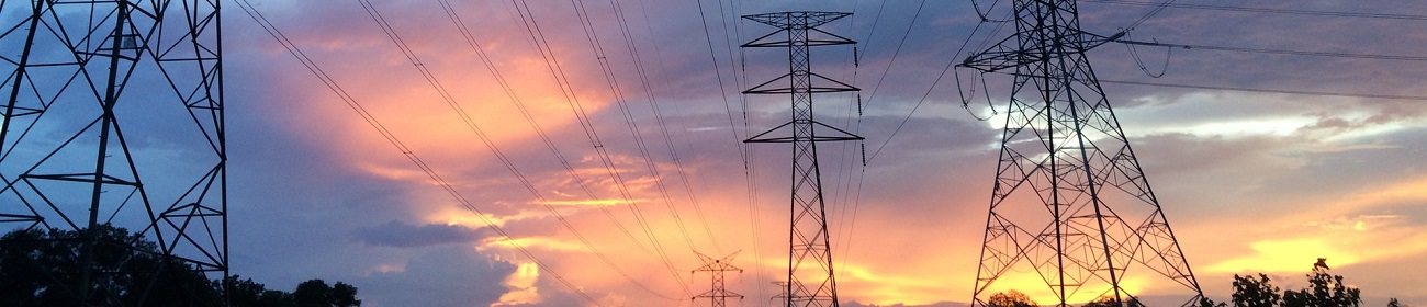 Electricity pylons against evening sky
